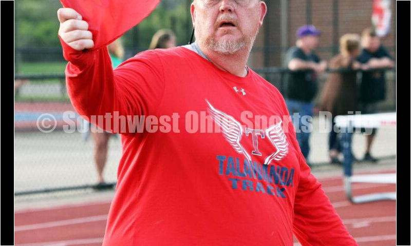 Talawanda High School coach Brad Hoblitzell does some flag work April 16, 2024, during the Dale Plank Invitational track & field meet at Talawanda. RICK CASSANO/STAFF