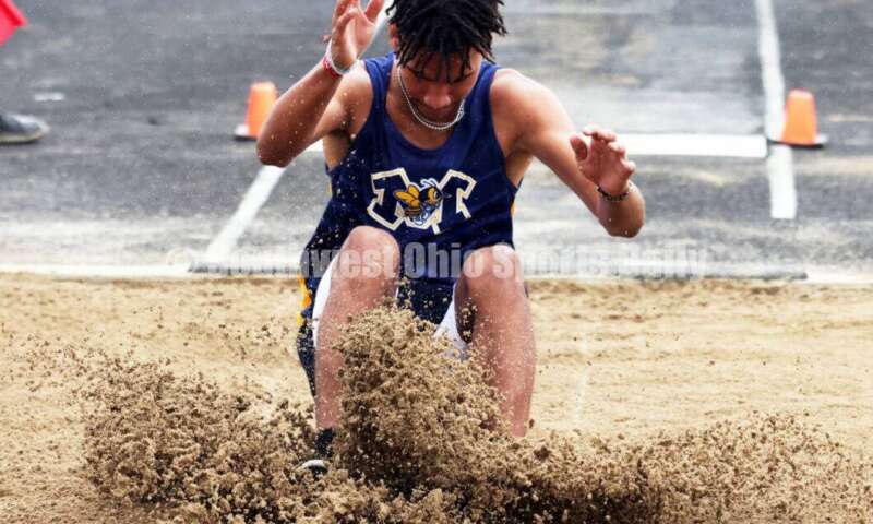 Monroe High School's Corey Williams-Carter makes a landing in the boys long jump May 15 2024, during the Division I district track & field meet at Bellbrook. RICK CASSANO/STAFF