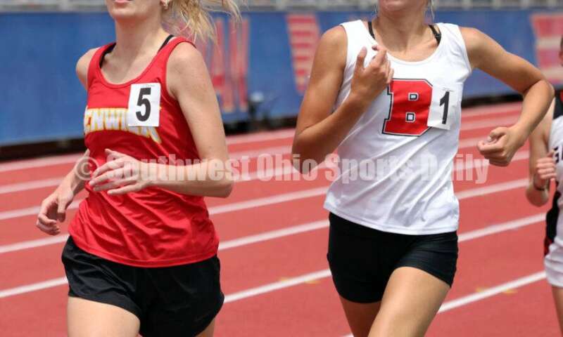 Fenwick High School's Morgan Blair (left) runs next to Bellefontaine's Grace Brown in the girls 1,600-meter race May 25, 2024, during the Division II regional track & field meet at Piqua. RICK CASSANO/STAFF