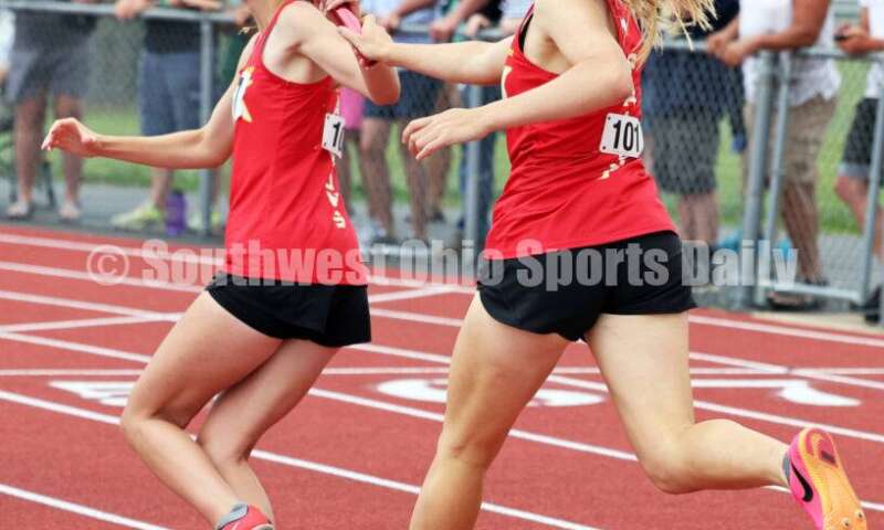 Fenwick High School's Sam Long passes the baton to Mackenzie Rohde in the girls 1,600-meter relay May 25, 2024, during the Division II regional track & field meet at Piqua. RICK CASSANO/STAFF