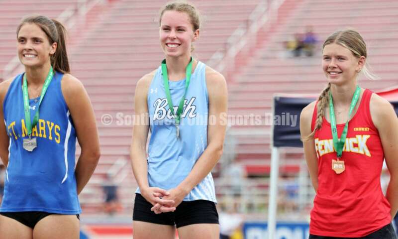 Fenwick High School's Mackenzie Rohde (left) poses with Lima Bath's Tatum Walsh (middle) and St. Marys Memorial's Syerra Greber on the podium after the girls 400-meter dash May 25, 2024, during the Division II regional track & field meet at Piqua. RICK CASSANO/STAFF