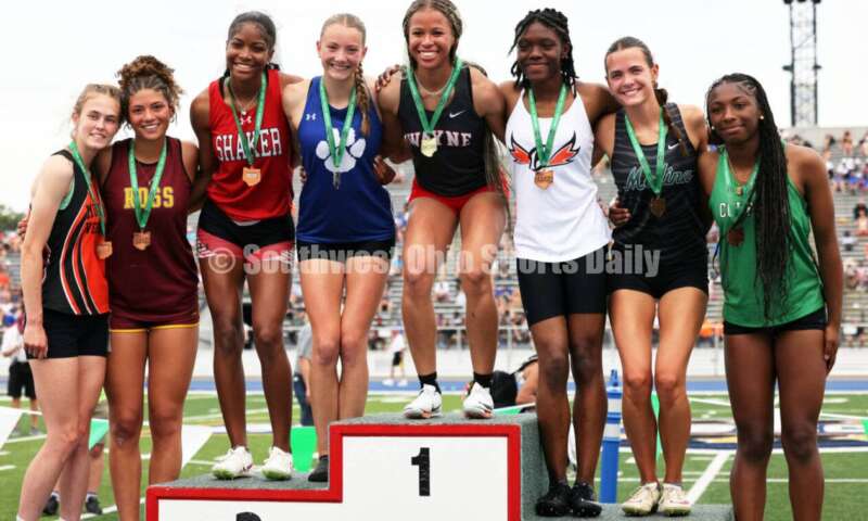 From left, Marissa Rutter of Mount Vernon, Myah Boze of Ross, Jennifer Rawls of Shaker Heights, Anna Wile of Hilliard Davidson, Ric'Keya White of Huber Heights Wayne, Faith Brown of Beavercreek, Lauren Dawson of Medina and Nadiya Webb of Dublin Coffman pose on the podium after the Division I girls 100-meter hurdles June 1, 2024, during the state track & field meet at Welcome Stadium in Dayton. Boze placed sixth. RICK CASSANO/STAFF