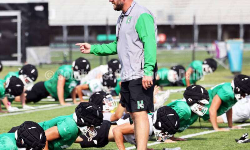 Harrison High School coach Derek Rehage instructs his team Aug. 14, 2024, during a football practice at the school in Harrison. RICK CASSANO/STAFF