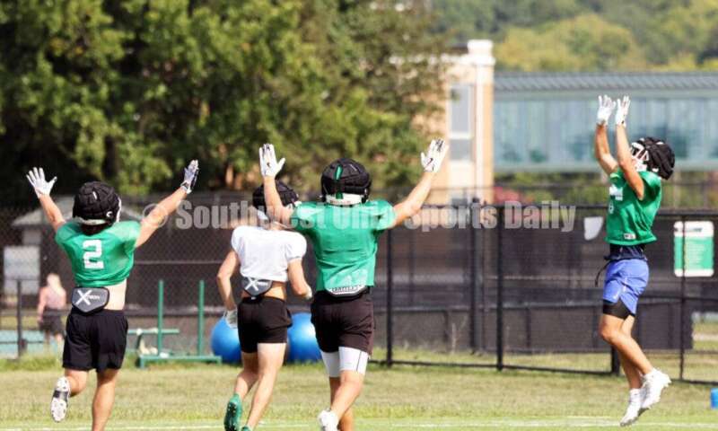 A long throw is up for grabs during Harrison High School's football practice Aug. 14, 2024, at the school in Harrison. RICK CASSANO/STAFF
