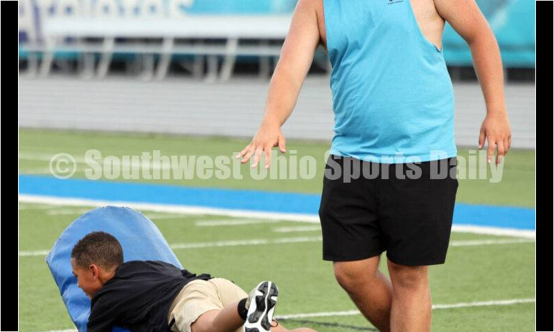 Hamilton High School senior Jett Phillips helps at youth football camp June 20, 2025, at Virgil Schwarm Stadium in Hamilton. RICK CASSANO/STAFF