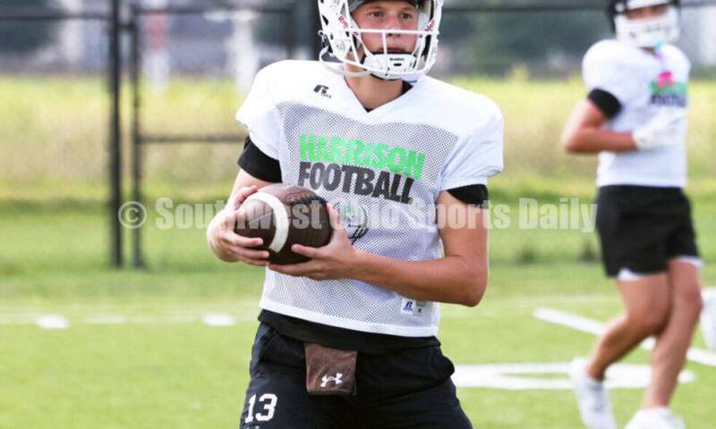 Harrison High School quarterback Brady Lawhon runs through a play Aug. 7, 2025, during a football practice at the school in Harrison. RICK CASSANO/STAFF