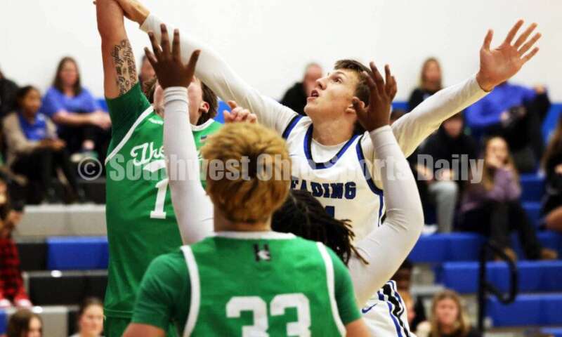 Harrison High School's Mitchell Mercurio (1) is fouled by Reading's Jorden Bemmes on Dec. 8, 2025, during a boys basketball game at Reading. Harrison won 62-42. RICK CASSANO/STAFF