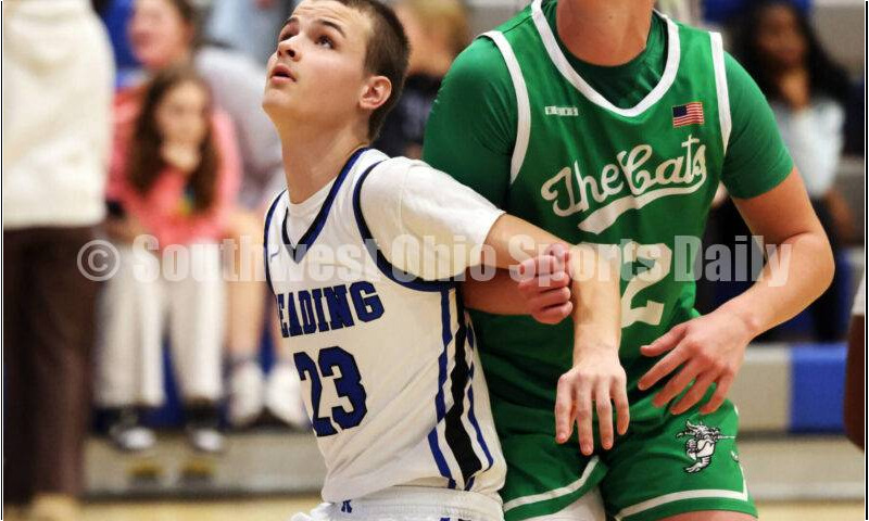 Harrison High School's Brady Lawhon (right) and Reading's Jared Webb eye a rebound Dec. 8, 2025, during a boys basketball game at Reading. Harrison won 62-42. RICK CASSANO/STAFF
